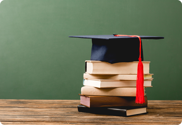Graduation cap resting on a stack of books